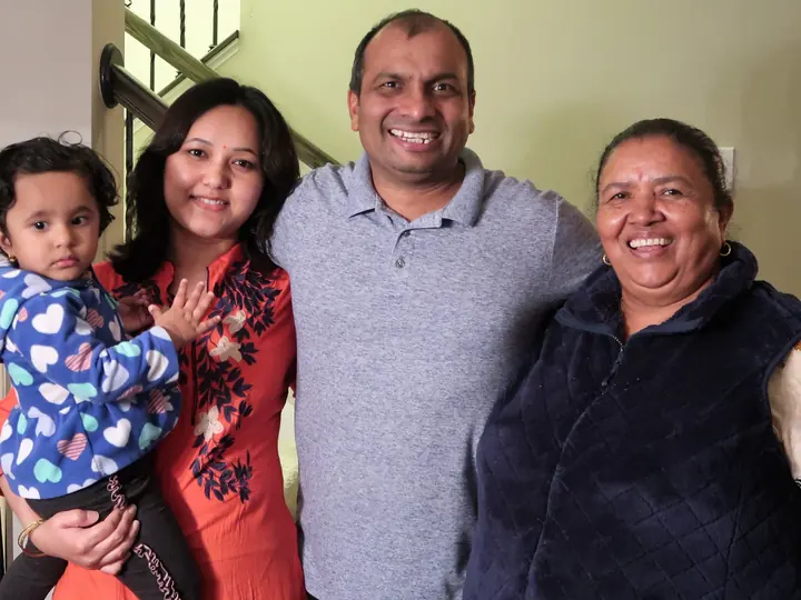 Smiling family at home with their agent after buying their house