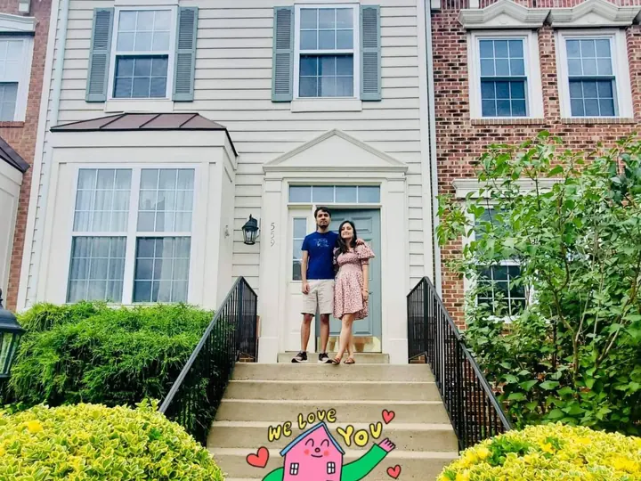 Couple on the front steps of their new townhome