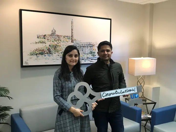 Couple holding the congratulations key at closing
