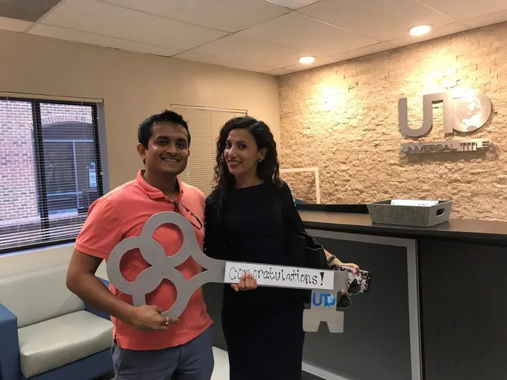 Couple holding the congratulations key