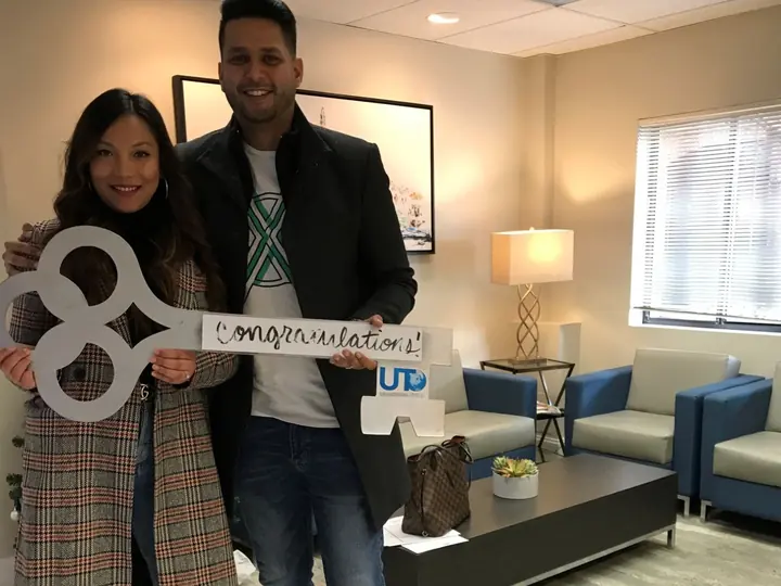 Couple with the congratulations key at closing