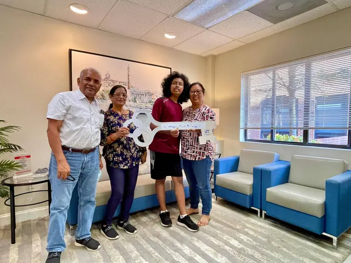 Family with the congratulations key after buying their home